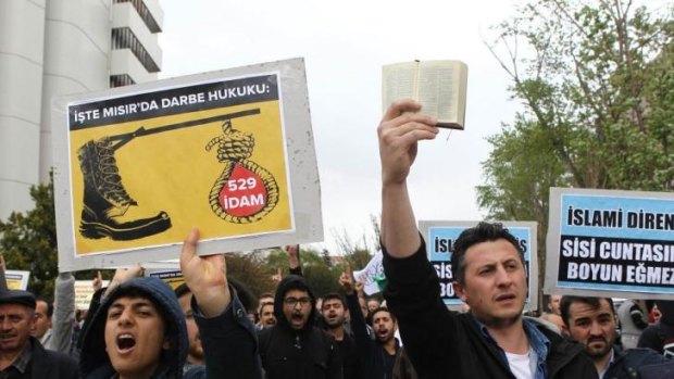 'Appalling abuse' of justice: Supporters of Egypt's Muslim Brotherhood protest against the mass death sentence pronounced on 529 people outside the Egyptian embassy in Ankara, Turkey.
