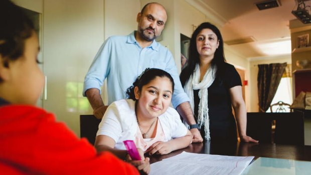 Nysha, 11, with her parents Saleem and Shazia Omar, has been privately tutored since grade 4. 'The tests are hard, but I really enjoy them,' she said.