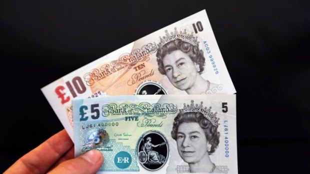 Out with the old: Britain's paper pound notes will be replaced.