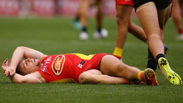 Trent McKenzie of the Suns lies on the ground.