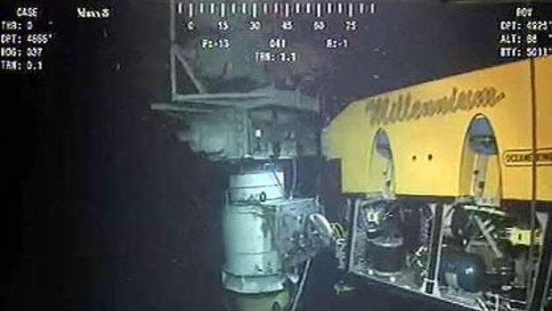 A still image from a live BP video feed shows robots installing the sealing cap over a gushing well in the Gulf of Mexico.