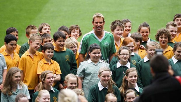Shane Warne poses with children at the Melbourne Stars press conference yesterday.