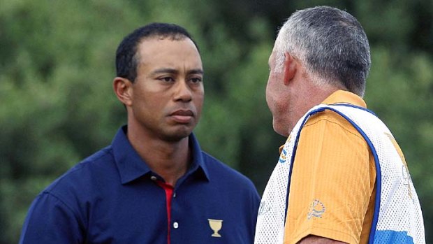 Firm grip: Tiger Woods and former caddie Steve Williams yesterday.
