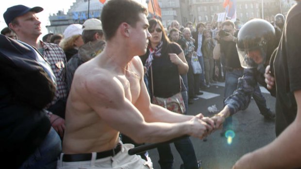 Denis Lutskevich, left, is detained by police during an opposition rally in Bolotnaya Square in Moscow in 2012. The former naval cadet and first-year student, 21-year-old Lutskevich was attending his first protest when he was detained, and is still in prison Monday May 6, 2013, on the first year anniversary of the protest.