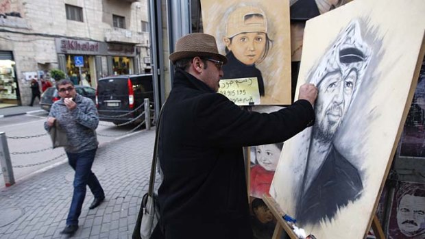 Artist in waiting &#8230; Abdul Hadi in the West Bank city of Ramallah paints a portrait of the late Palestinian leader Yasser Arafat. Tests on samples from Arafat's remains are being tested for possible poison.