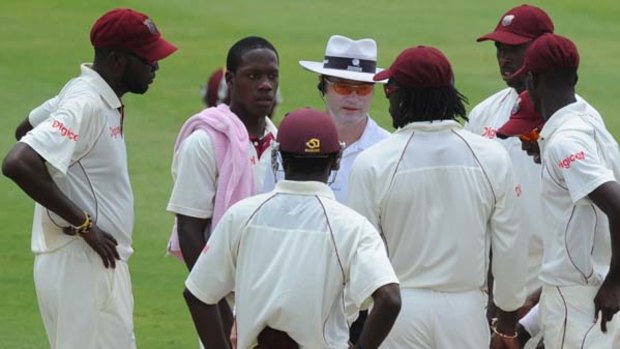 West Indies players talk with Australian umpire Simon Taufel after an alleged spitting incident involving South African fast bowler Dale Steyn.