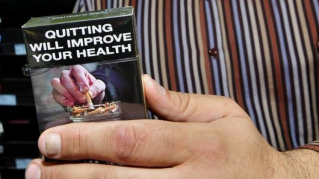 Behind closed doors: Plain packaging has pushed smoking out of sight, out of mind.