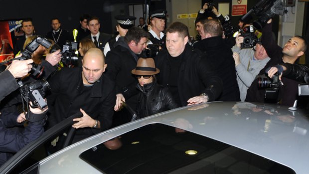 Split ... British singer Cheryl Cole is surrounded by photographers as she leaves London's Heathrow Airport.