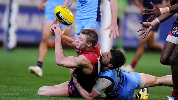 The red and the blue: Carlton's Marc Murphy takes on Melbourne's Colin Sylvia.