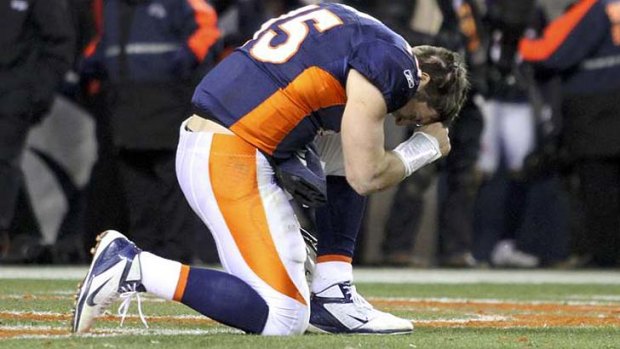 Tebowing ... Tim Tebow goes down on one knee and clenches his fist to his forehead as he prays during a game for his former team Denver Broncos.