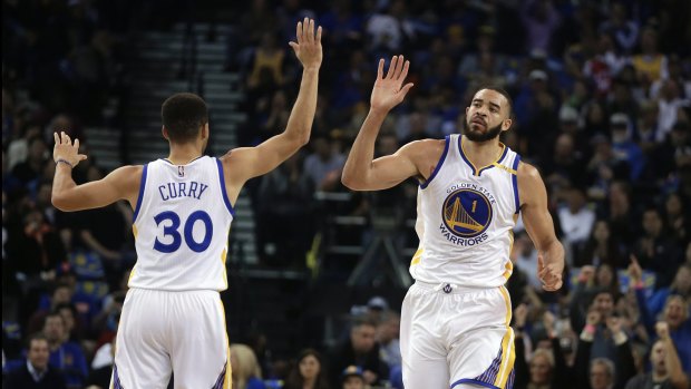 Barrage: Stephen Curry and JaVale McGee celebrate a score.