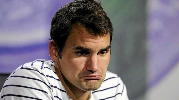 Roger Federer of Switzerland grimaces during a press conference after his defeat at the hands of the Ukraine's Sergiy Stakhovsky.