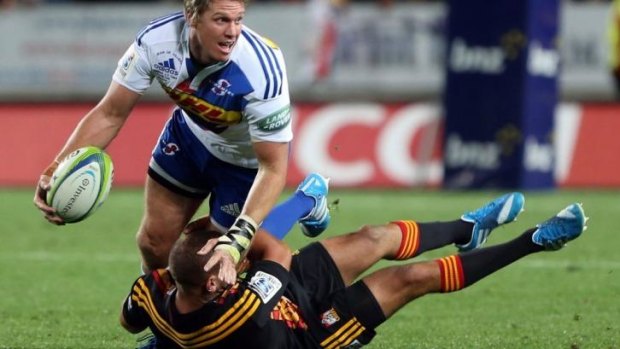 Jean De Villiers looks to offload out of the tackle of Aaron Cruden.