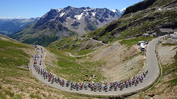 The grind: The pack climbs the Col du Galibier during the Tour de France stage between Embrun and L'Alpe d'Huez.