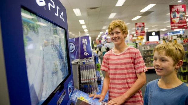 From left, James, 15 and Jack, 11 play the latest game consoles that are available for Christmas shoppers at Harvey Norman.