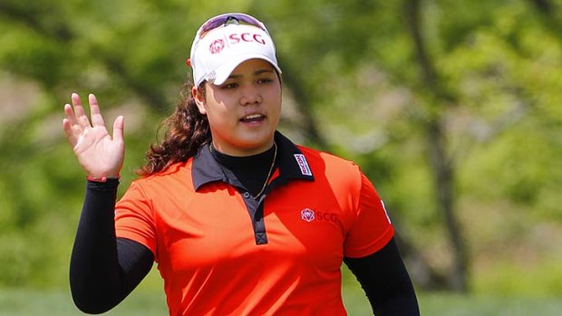 Ariya Jutanugarn acknowledges the crowd after making birdie and finishing her round on the 18th hole during the first round of the Kingsmill Championship in Williamsburg, Virginia.