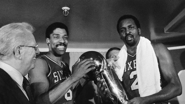 Champions: Moses Malone, right, celebrates the 1983 NBA Championship win with Julius 'Dr. J' Erving.