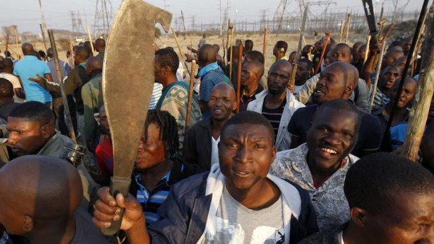 Thousands of striking miners armed with machetes and sticks faced off with South African police at Lonmin's Marikana mine.