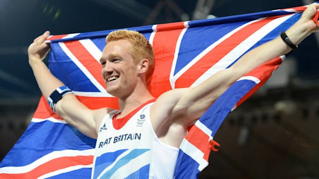 Crowd pleaser ... Greg Rutherford celebrates winning gold.