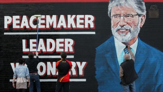 Painters put the final coat of paint on a newly created mural of Sinn Fein President Gerry Adams in Belfast, Northern Ireland, this week. 