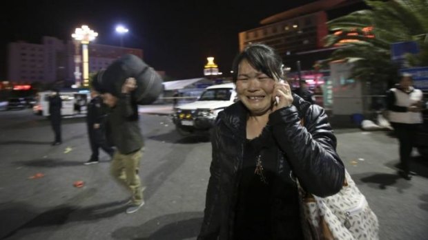 A woman reacts to the bloody attack outside Kunming railway station.