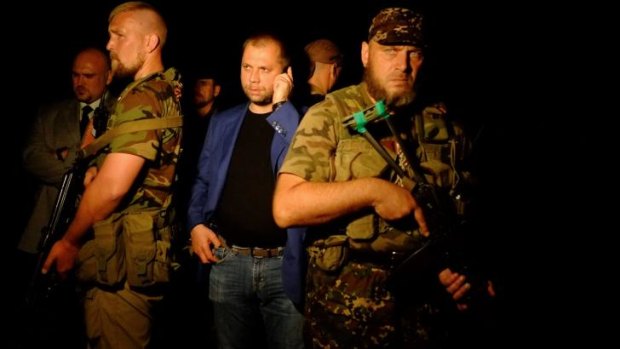 Alexander Borodai (centre) at the MH17 crash site. He has been reportedly recalled to Moscow.