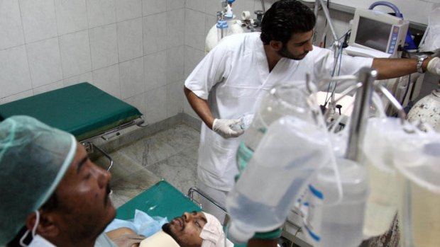 Libyan medics treat a wounded man at a hospital.