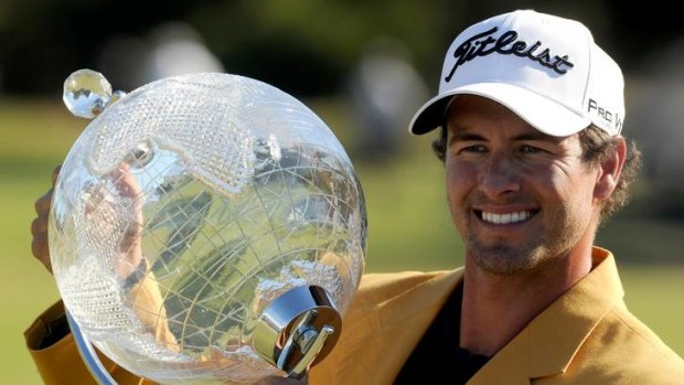 Relief .... Adam Scott with the trophy and the gold jacket.