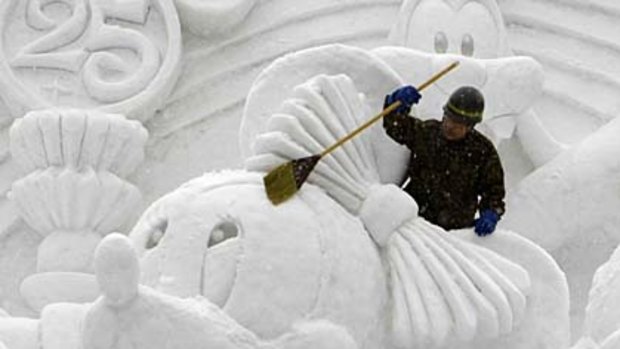 Snap frozen ... Mickey Mouse gets a brush up at the Sapporo Snow Festival.