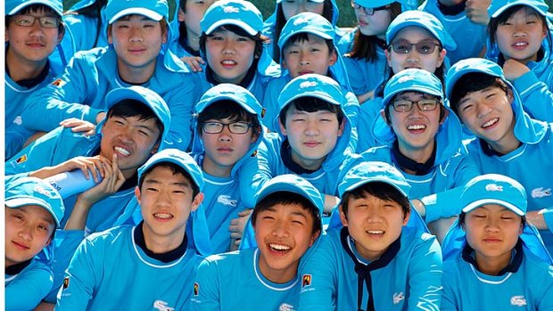 Chinese and Korean ballkids ready to help out at the Australian Open.