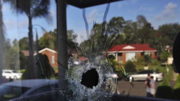 Yesterday's drive-by shooting, with the reflection of the homes of Coleridge Road in Wetherill Park.