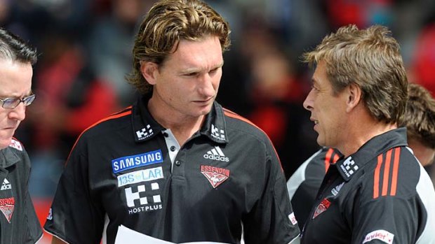 Essendon coach James Hird gets a few tips from Mark Thompson.