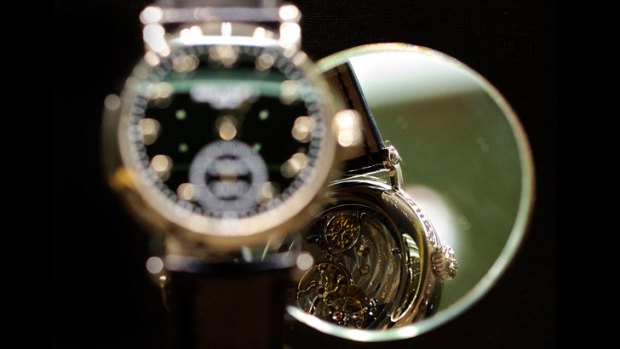 The movement of a 5539G-001 wristwatch in white gold, by Patek Philippe, is reflected in a mirror.