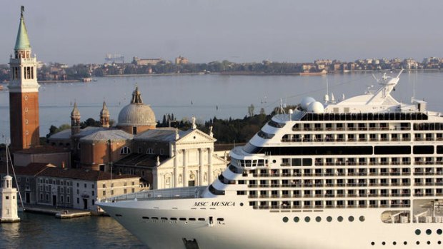 The MSC Musica ship dwarfs the church of San Giorgio Maggiore as it arrives in Venice.