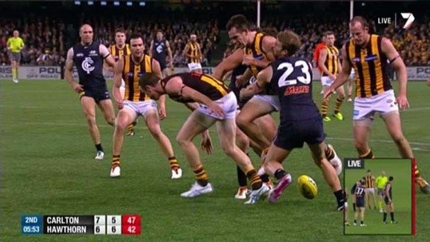 Hawthorn's Luke Hodge delivers a bump to Carlton's Lachie Henderson.