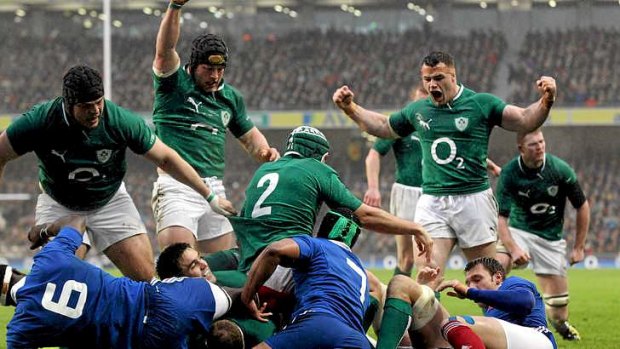 Ireland's Jamie Heaslip scores a try as teammates celebrate.