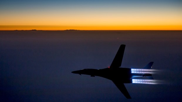 In this photo released by the US Air Force, a plane flies over northern Iraq after conducting airstrikes in Syria against Islamic State group targets in Syria.