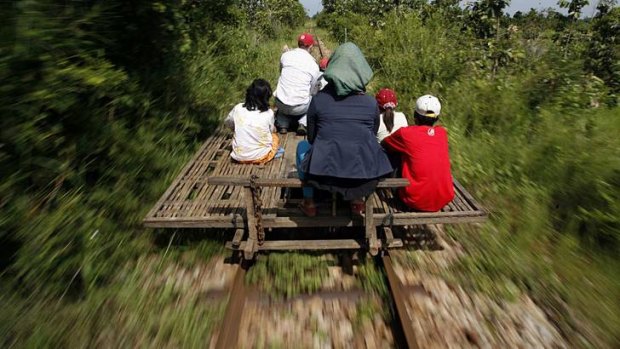 Restoing links ... Cambodians ride a bamboo train near a reopened  station in Pusat province in 2010.