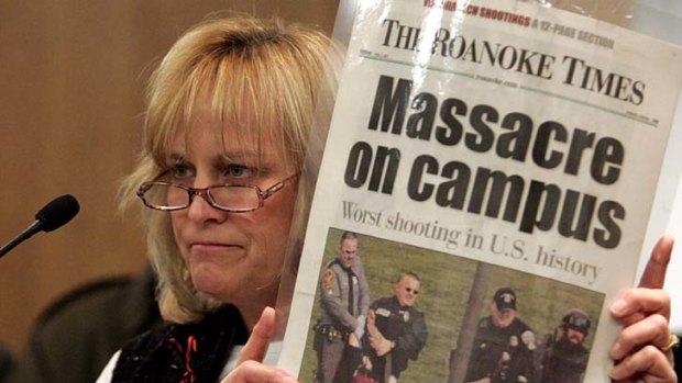 Mass killing ... Suzanne Grimes holds up a picture of her injured son after the Virginia Tech shooting in 2007.