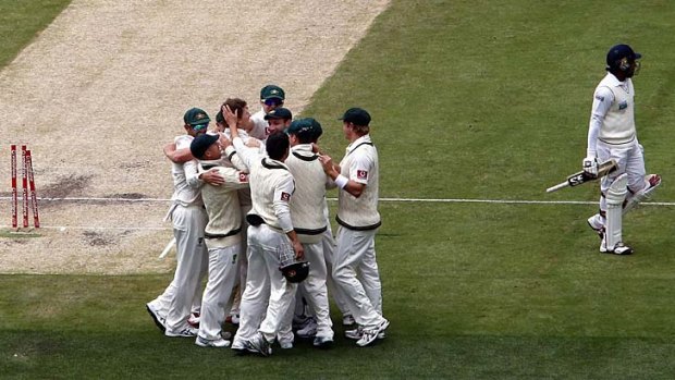 Jackson Bird celebrates with teammates after bowling Sri Lanka's captain Mahela Jayawardene.