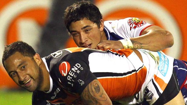 Benji Marshall of the Tigers dives over for a try against the Warriors.