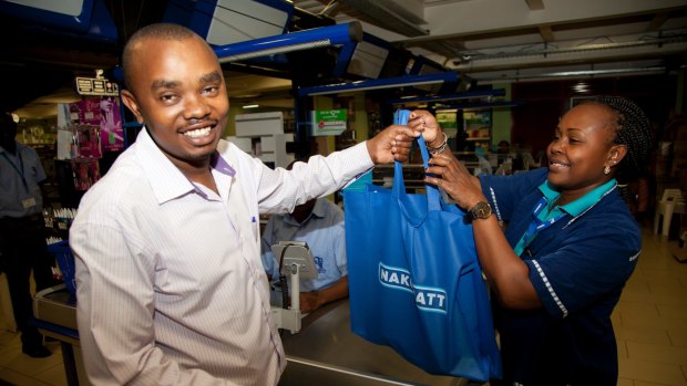A customer carries his shopping in a cloth carrier bag in Nairobi, Kenya.
