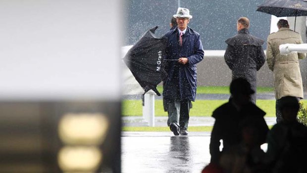 Punters cover up at Randwick Racecourse on Saturday.
