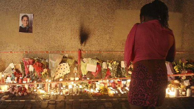 Vigil &#8230; tributes for Tia, seen in the photo, near her grandmother's house on a council estate in London.