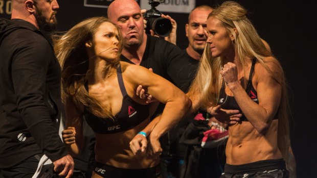 Ronda Rousey (l) confronts Holly Holm (r) during their weigh in at Etihad Stadium.