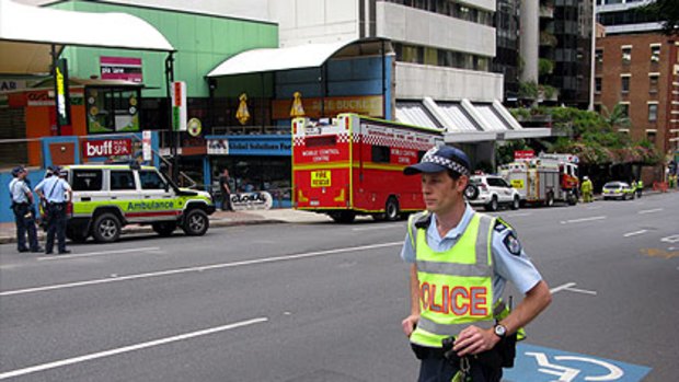 Police close down Adelaide Street after a suspicious package was delivered to a building housing the Department of Immigration and Citizenship offices.
