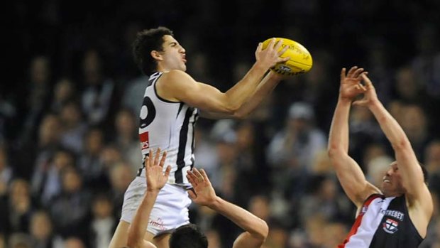 Taking flight: Alex Fasolo propels himself to great heights as he marks over teammates and St Kilda's Jarryn Geary.