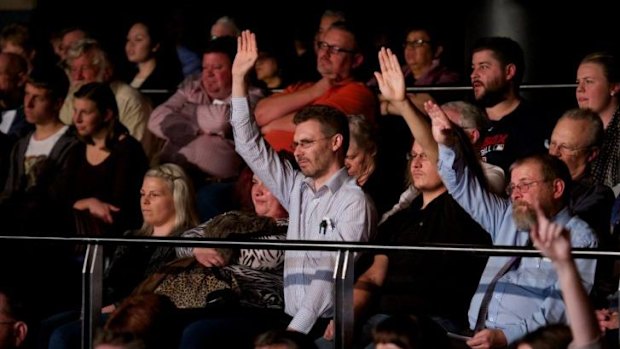 Barrage of queries ... Q&A audience members raise their hands to ask Treasurer Joe Hockey questions about the Federal Budget.