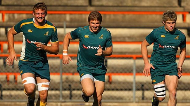 Dean Mumm, Drew Mitchell and James O'Connor run during a Wallabies training session in 2009.