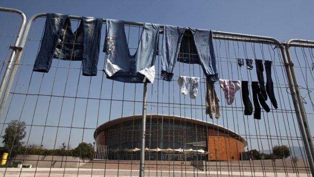 Laundry hangs to dry on the fencing around the 2004 Olympic Tae Kwon Do centre outside Athens.